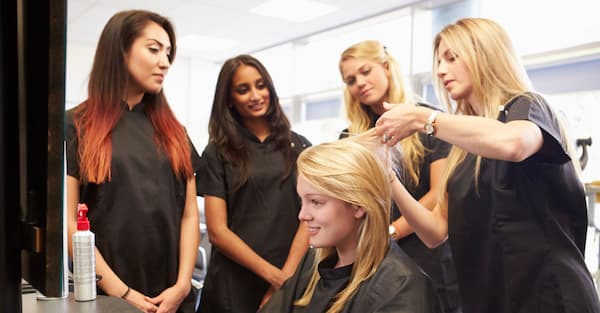hairstylists teaching how to cut and style hair